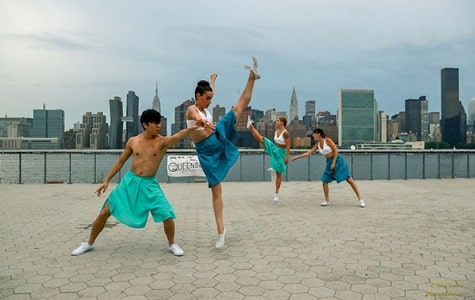 dancers perform at the Long Island City waterfront facing the Manhattan skyline